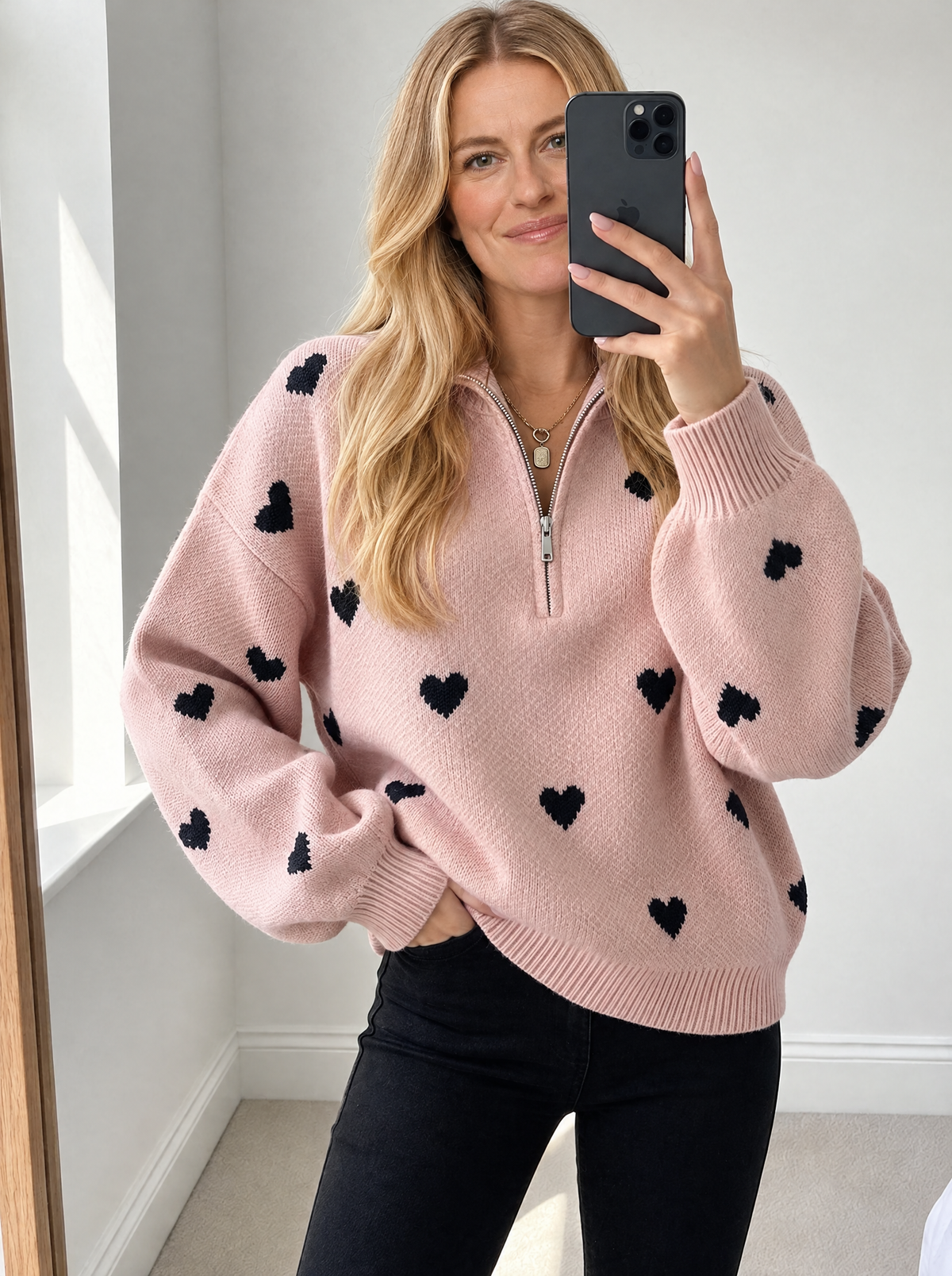 Blonde model wearing women's heart pattern knit sweater