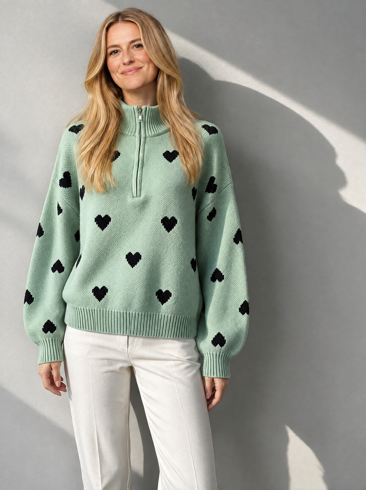 Blonde model wearing zipper knit sweater in light green
