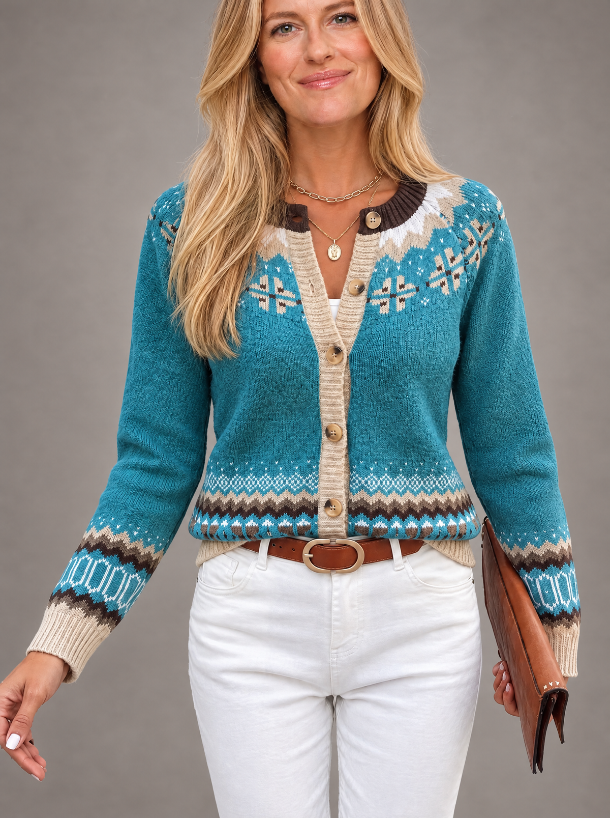 Blonde model wearing Isle jacquard knitted round neck cardigan on grey background